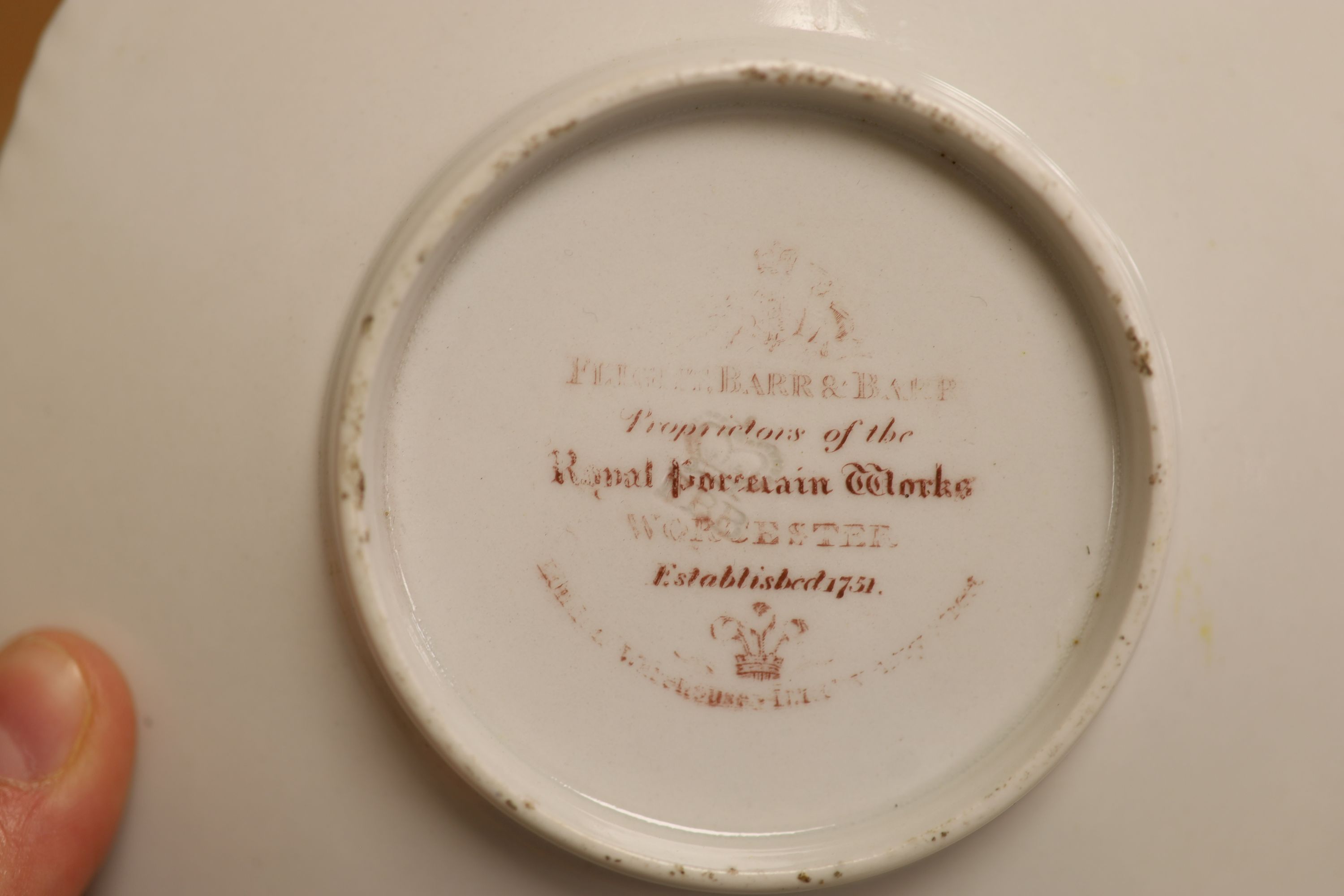A Flight Barr & Barr cup and saucer, painted with Binstead cottage, Isle of White and Land Gate, Winchelsea, the saucer with country folk diameter 15cm